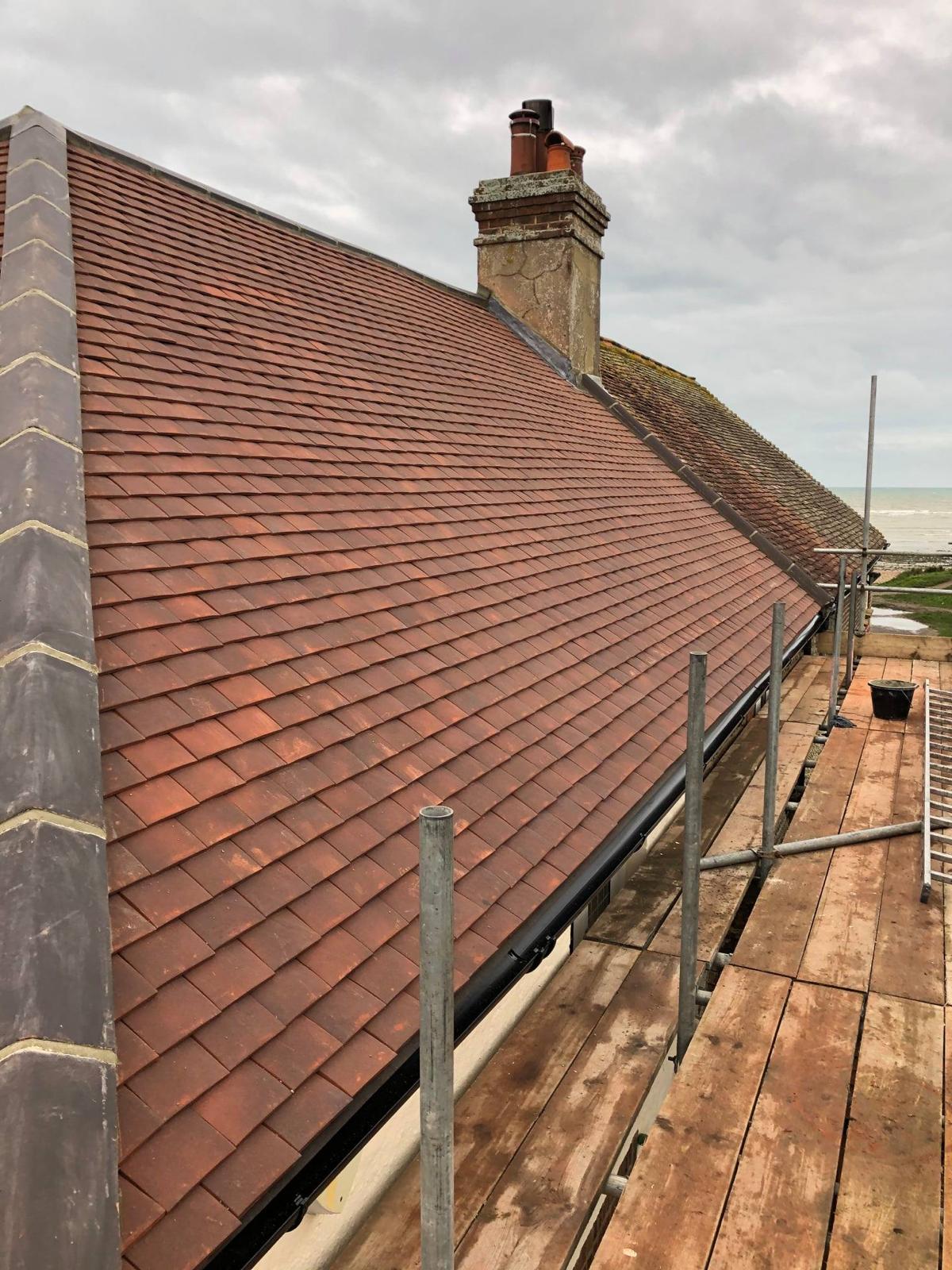 Freshly tiled clay roof on a coastal Hampshire residential property by Huntley & Heath Developments
